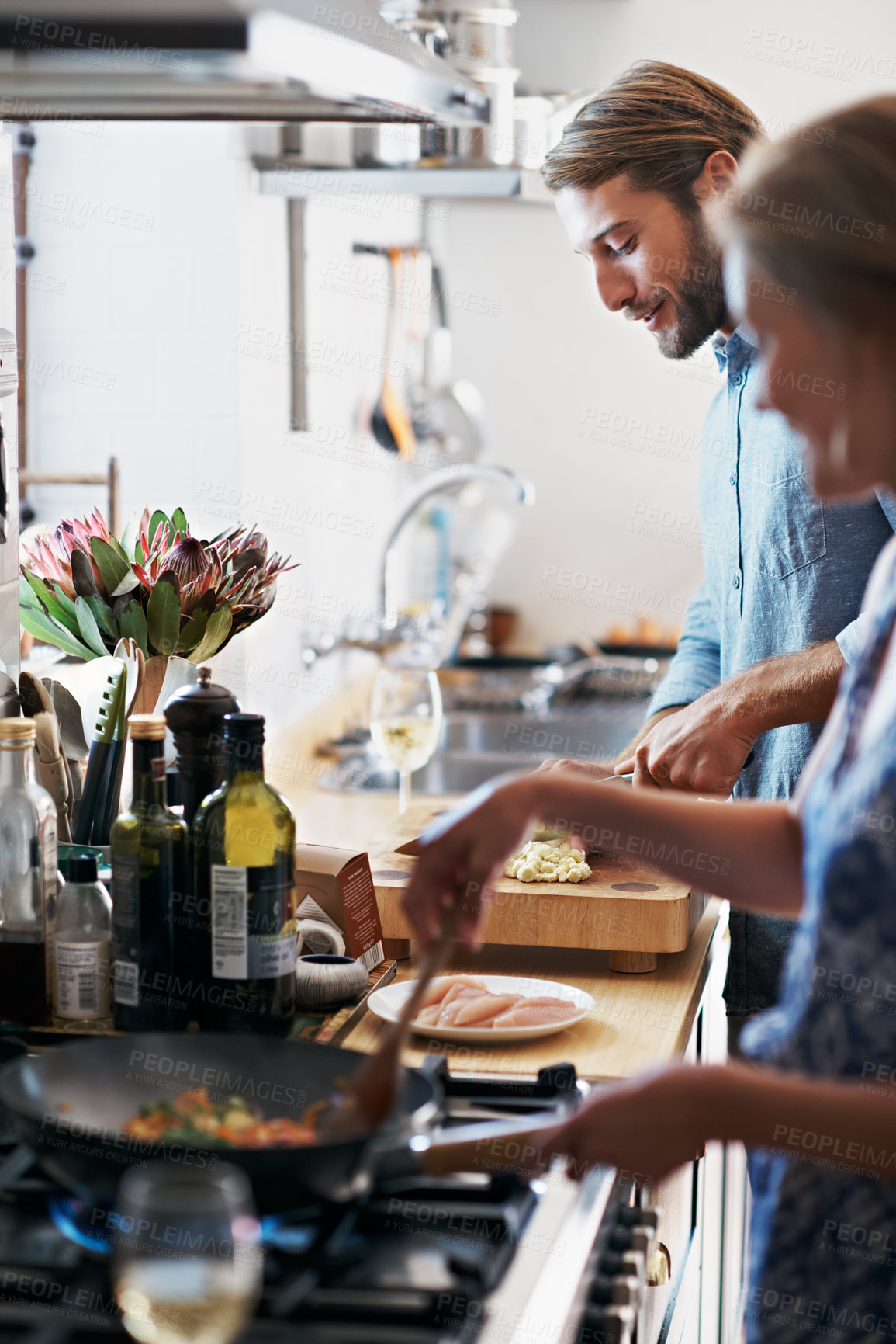Buy stock photo Couple, talking and cooking in kitchen for romance, conversation and recipe for nutrition in home. People, bonding and prepare meal together for dinner, communication and support with food in house
