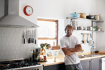Buy stock photo Portrait of a young man in pajamas standing in his kitchen in the morning