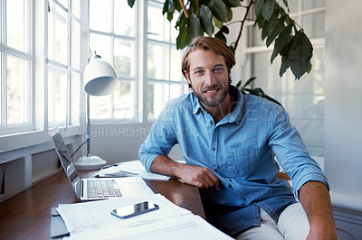 Buy stock photo Portrait of a young man working on a laptop at home