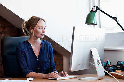 Buy stock photo Shot of a young woman using a computer in the study at home