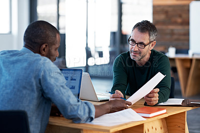 Buy stock photo Cropped shot of two businessman talking over a desk