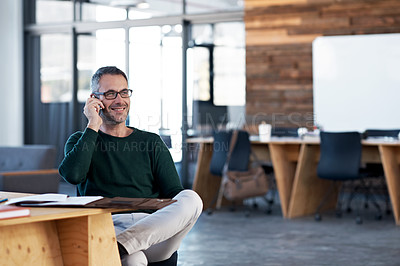 Buy stock photo Cropped shot of a handsome businessman talking on his cellphone