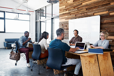 Buy stock photo Cropped shot of a group of colleagues working in the office