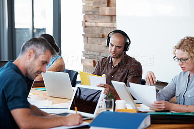 Buy stock photo Cropped shot of a group of colleagues working in the office