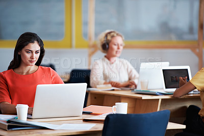 Buy stock photo Cropped shot of an attractive businesswomen working on a laptop