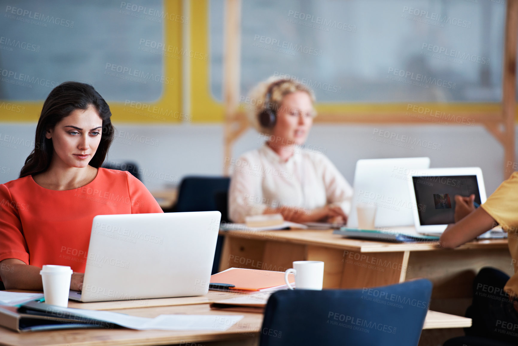 Buy stock photo Cropped shot of an attractive businesswomen working on a laptop