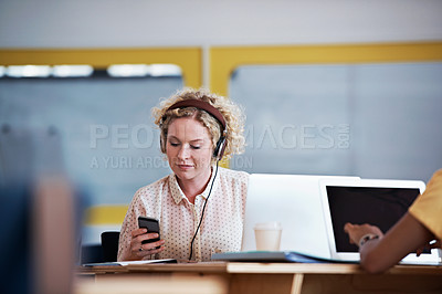 Buy stock photo Cropped shot of an attractive businesswoman using her cellphone in the office