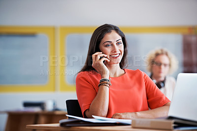 Buy stock photo Cropped shot of an attractive businesswoman talking on her cellphone in the office