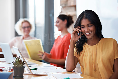 Buy stock photo Cropped shot of an attractive businesswoman talking on her cellphone in the office