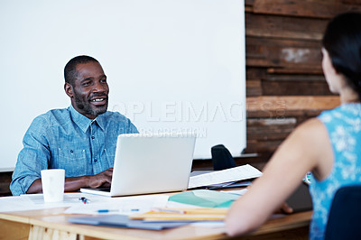 Buy stock photo Cropped shot of two colleagues talking across a table