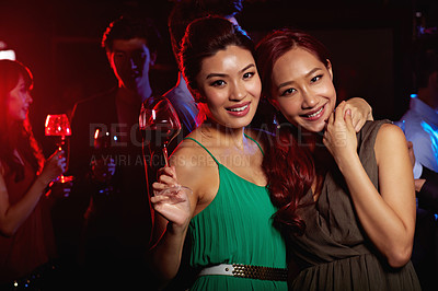 Buy stock photo Portrait of two young woman enjoying themselves in a nightclub