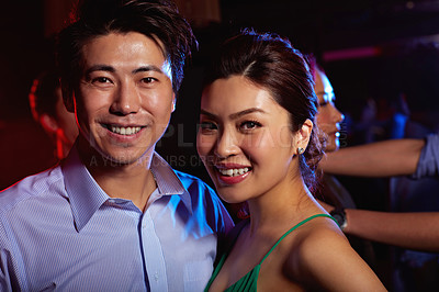 Buy stock photo Portrait of a young couple enjoying a night out together in a bar