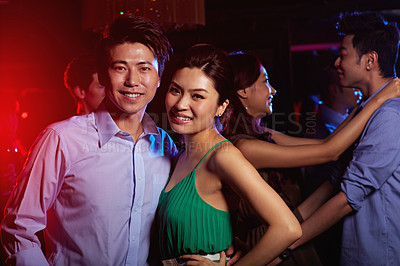 Buy stock photo Portrait of a young couple enjoying a night out together in a bar
