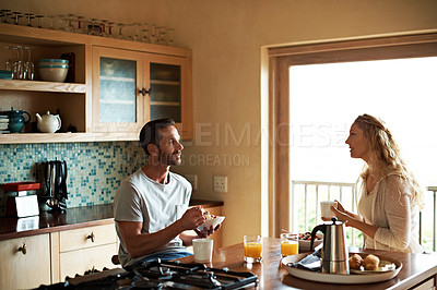 Buy stock photo Cropped shot of a couple having breakfast in the kitchen
