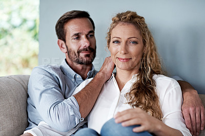 Buy stock photo Shot of a couple relaxing on their living room sofa