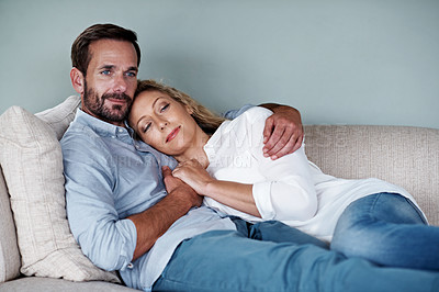 Buy stock photo Shot of a couple relaxing on their living room sofa