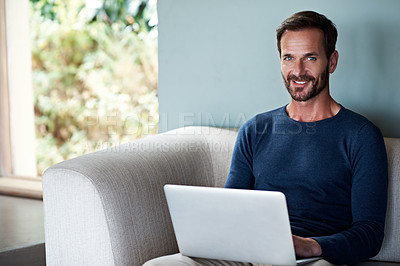 Buy stock photo Portrait of a man using his laptop at home