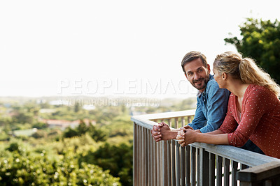 Buy stock photo Shot of a couple talking on their balcony