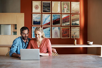 Buy stock photo Cropped shot of a couple using a laptop at home