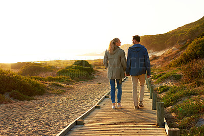 Buy stock photo Rearview shot of an adventurous couple walking outdoors