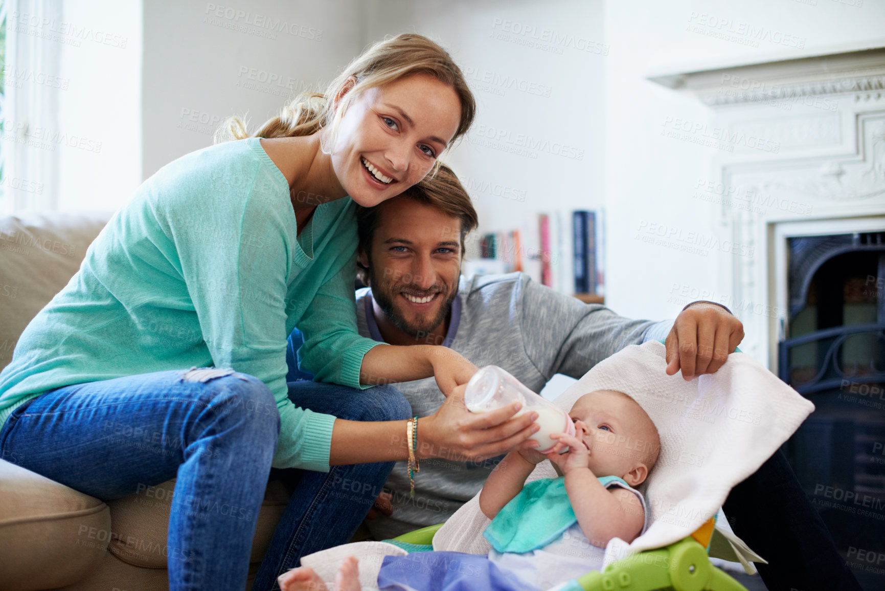 Buy stock photo Mother, father and feeding with baby bottle for health, child development and nutrition in home. Milk, happy family and infant kid with formula drink, love or care with portrait of parents for growth