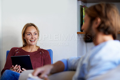 Buy stock photo Shot of a young couple relaxing in their living room