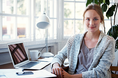 Buy stock photo Portrait of a young woman sitting at her laptop at home