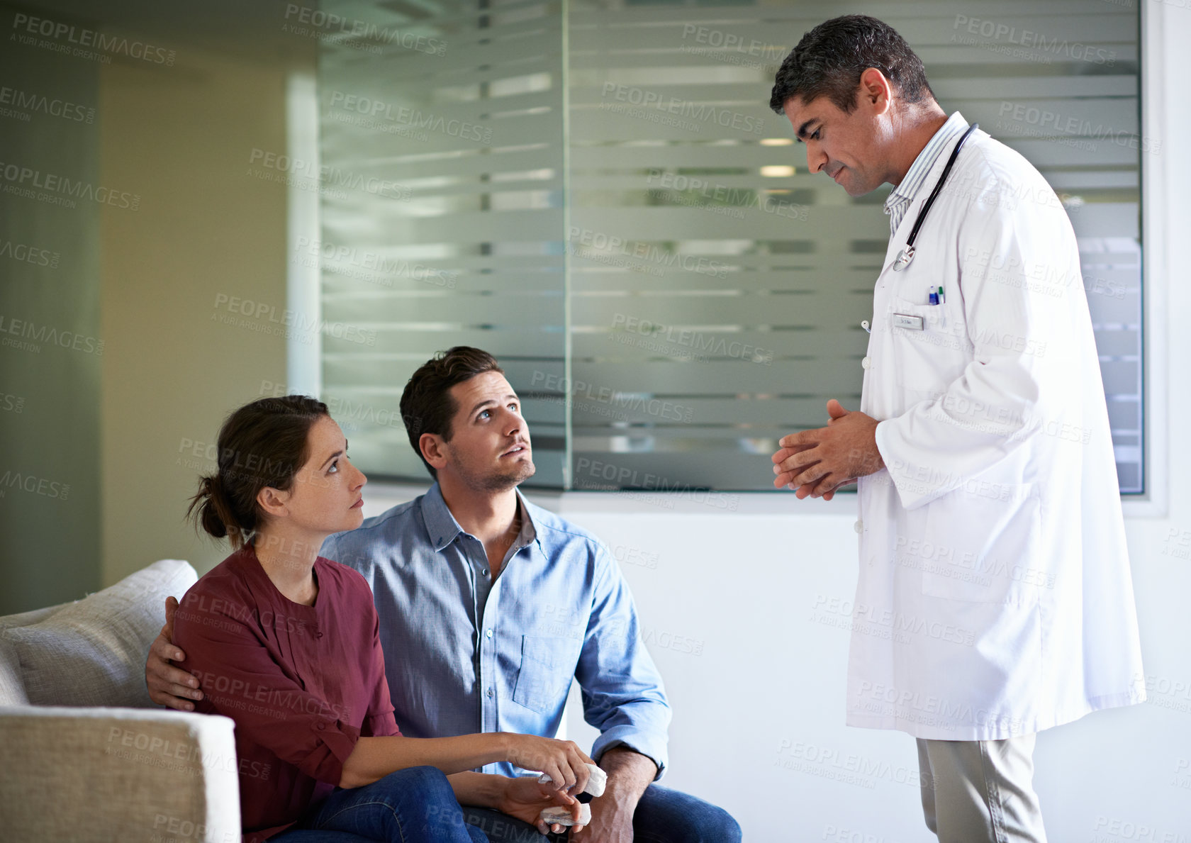 Buy stock photo Doctor, couple or breaking news in hospital with concern for treatment or medical complication. Man, healthcare worker or surgeon talking with family of patient for serious health condition in clinic