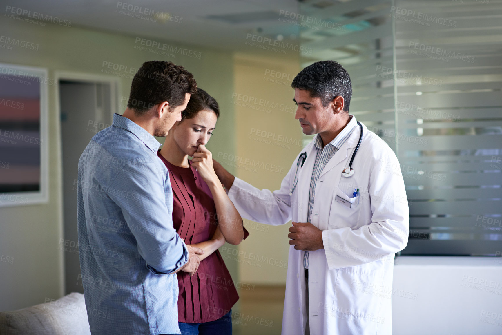 Buy stock photo Doctor, hospital and couple with bad news for health concern, fail treatment or medical complication. Man, healthcare worker or surgeon talking with empathy or family of patient for serious condition