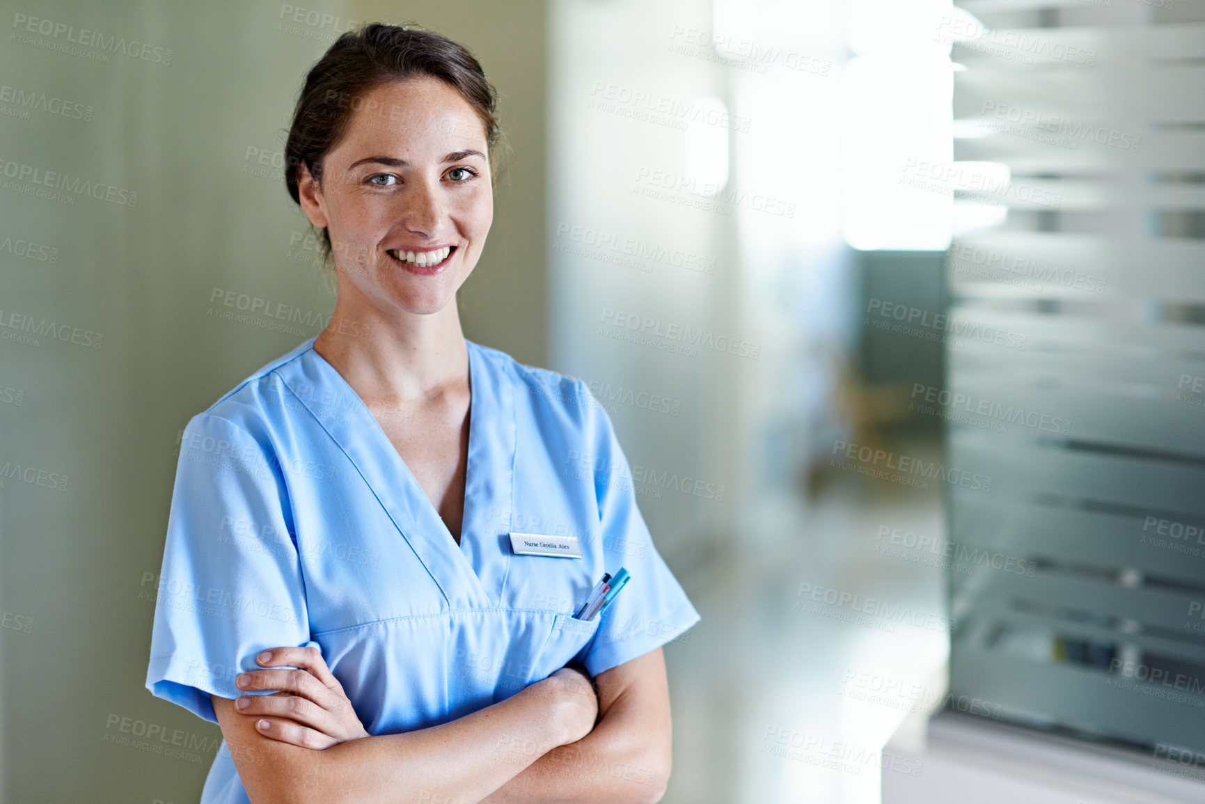 Buy stock photo Happy, nurse and woman with arms crossed in hospital, healthcare or confident for career development. Clinic, medical professional and person with smile, portrait and pride with health job in USA