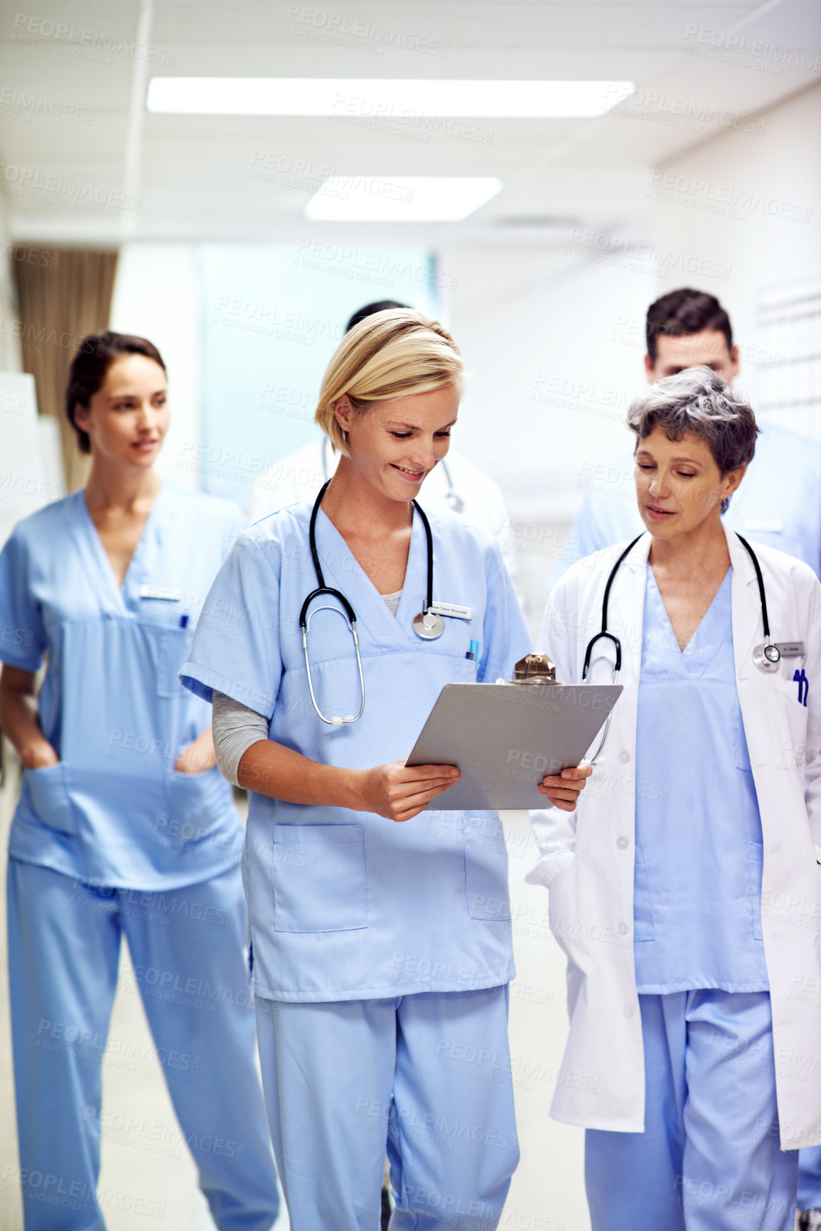Buy stock photo Hospital, clipboard and doctors walking in hallway for discussion, patient feedback and consulting. Healthcare, team and people in corridor for talking, surgery report and meeting for medical service