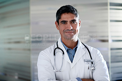 Buy stock photo Portrait of a confident mature doctor standing in a hospital