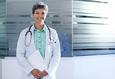 Buy stock photo Portrait of a confident mature doctor standing in a hospital