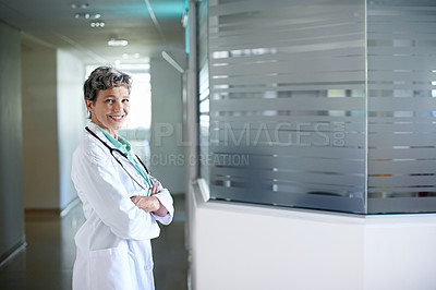 Buy stock photo Portrait of a confident mature doctor standing in a hospital