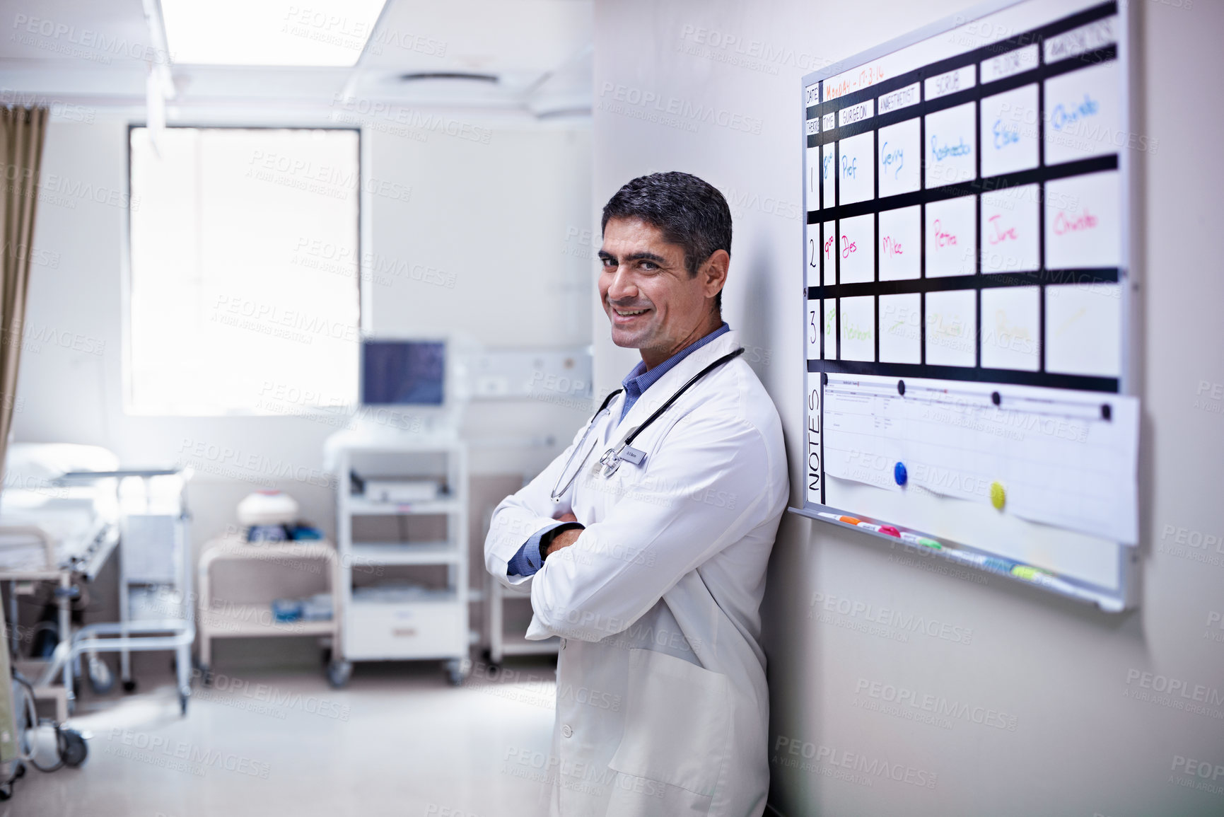 Buy stock photo Doctor, smile and man with arms crossed in hallway, health services and confident for career growth. Clinic, healthcare professional and happy person with medical duty, portrait and wellness job