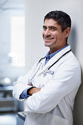 Buy stock photo Portrait of a confident mature doctor standing in a hospital