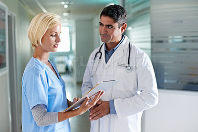 Buy stock photo Shot of two doctors having a discussion in a hospital