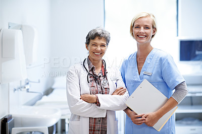 Buy stock photo Portrait of two confident doctors standing together in a hospital