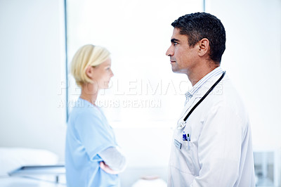 Buy stock photo Profile of two confident doctors standing in a hospital