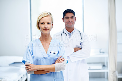 Buy stock photo Portrait of two confident doctors standing together in a hospital