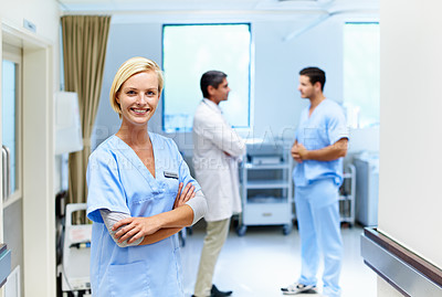 Buy stock photo Portrait of a confident doctor with medical staff in the background