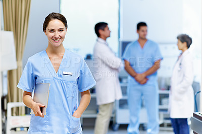Buy stock photo Portrait of a confident doctor with medical staff in the background
