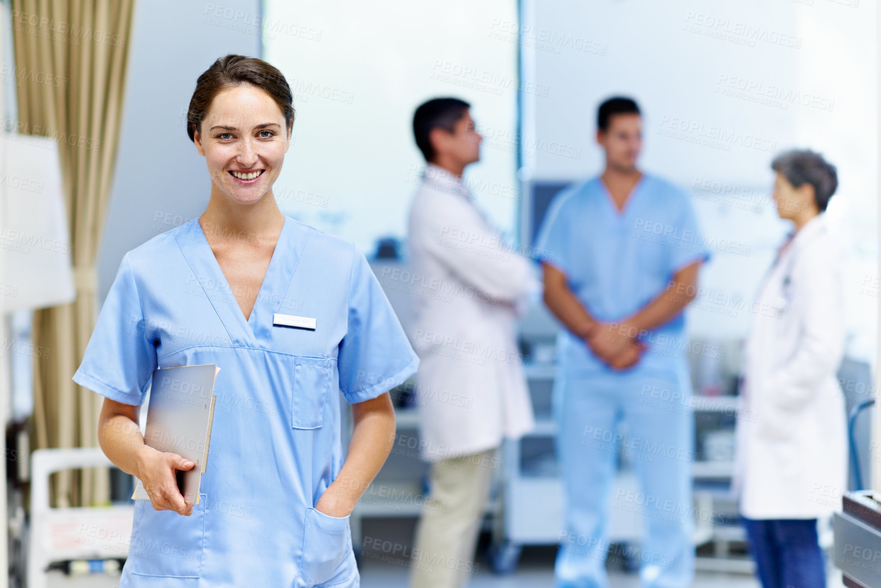 Buy stock photo Portrait of a confident doctor with medical staff in the background