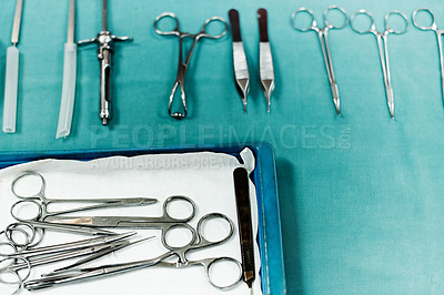 Buy stock photo Shot of assorted surgical instruments on a table