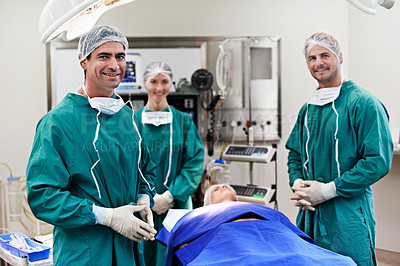 Buy stock photo Portrait of a team of surgeons in an operating theatre