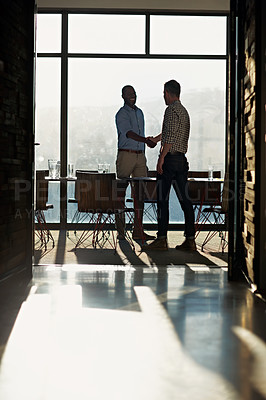 Buy stock photo Full length shot of two businessmen shaking hands after a meeting