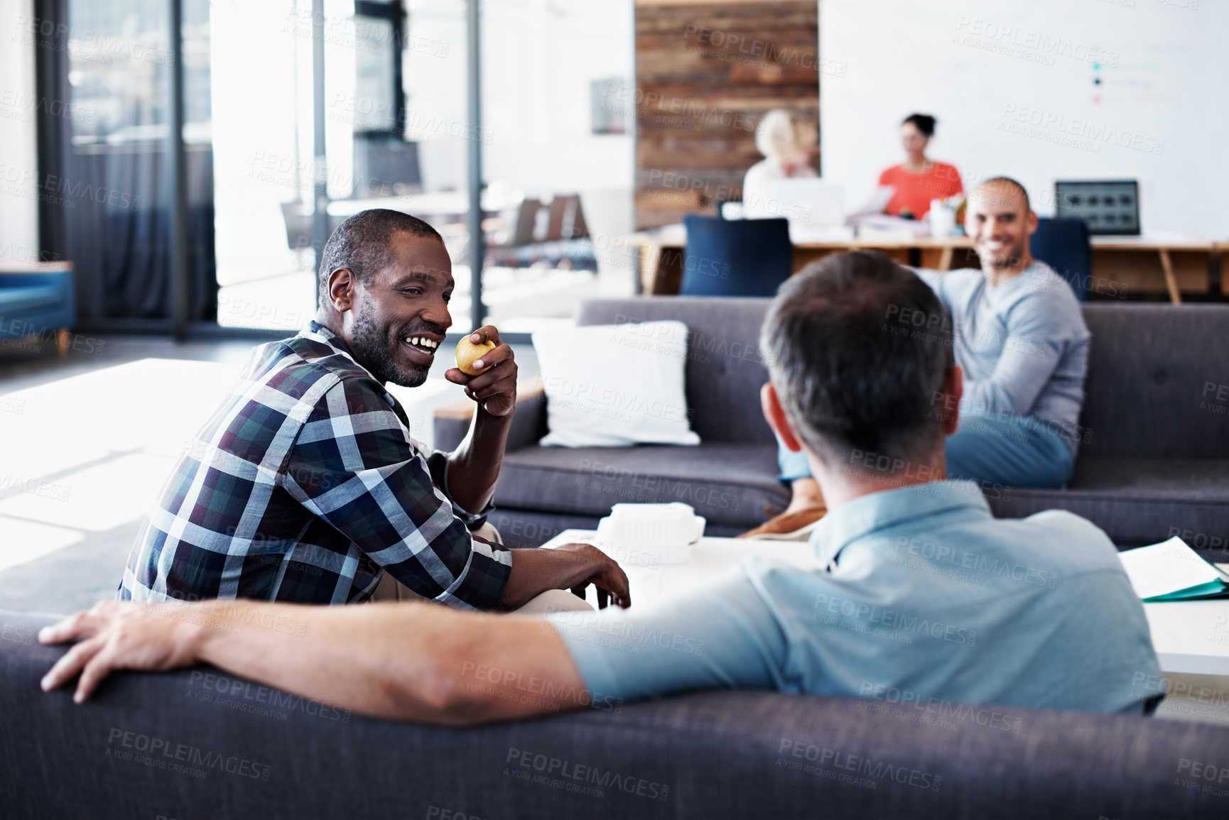 Buy stock photo Discussion, happy and business men on sofa in office for advice, feedback or tips on startup. Planning, talking and team of creative editors in conversation for review on project in workplace.