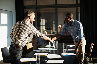 Buy stock photo Cropped shot shot of two businessmen shaking hands after a meeting