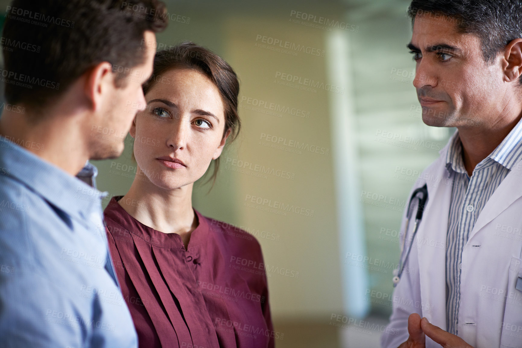 Buy stock photo Concern, couple and doctor in hospital waiting room for medical discussion, feedback or review. Consulting, grief and healthcare professional speaking to sad people in lobby of clinic for report
