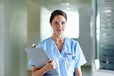 Buy stock photo Portrait of a young female doctor standing in a hospital corridor